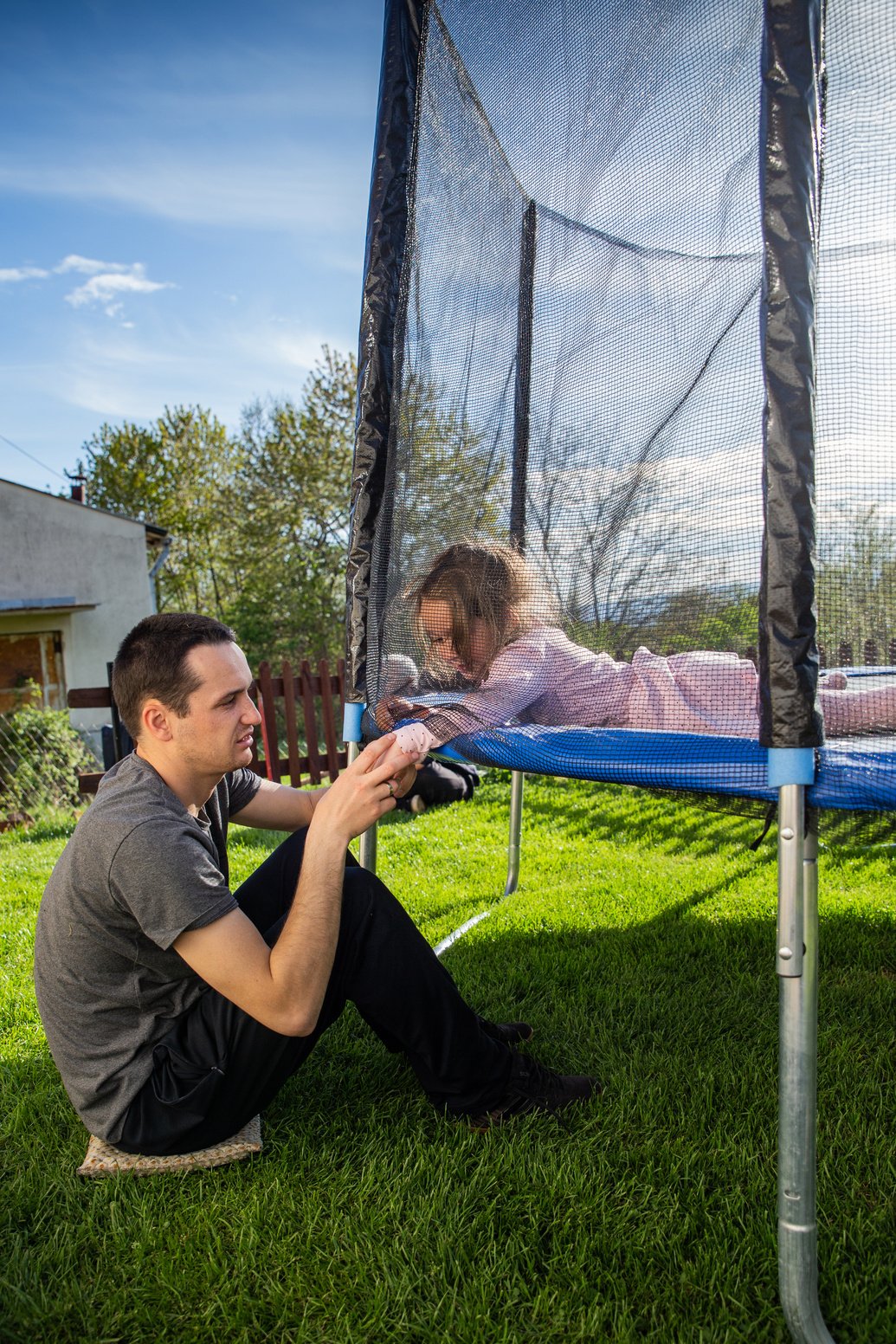 Father fixing the trampoline